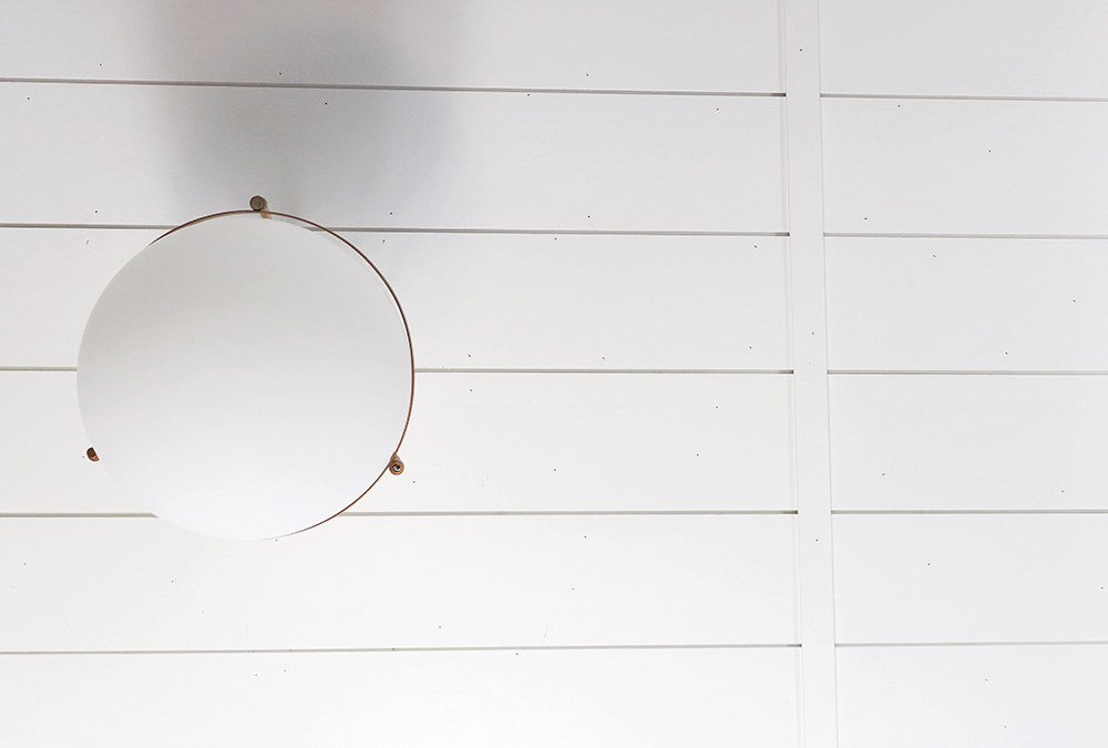 ceiling with white shiplap and a light fixture