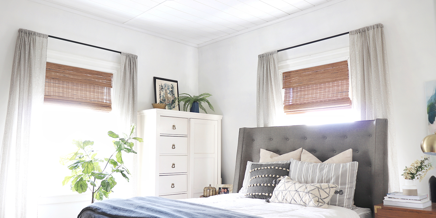 bedroom with curtains and plants and white shiplap ceiling