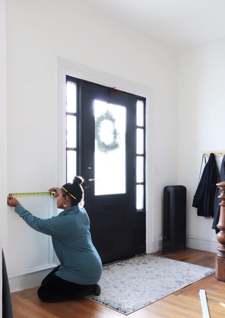 woman measuring interior of her home